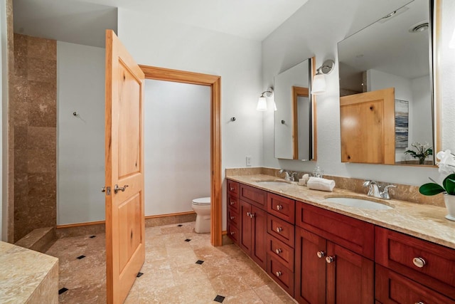 bathroom featuring toilet and vanity