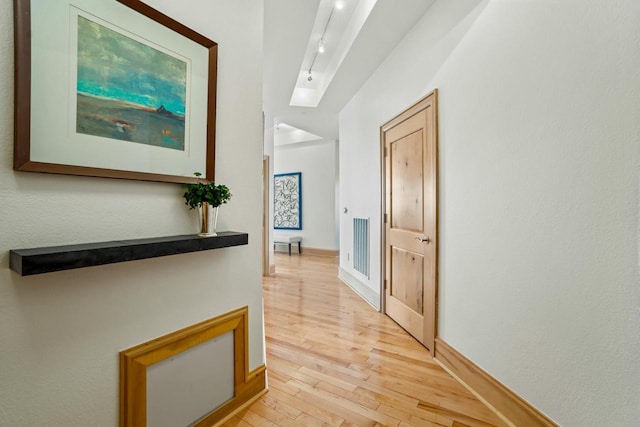 corridor with light wood-type flooring