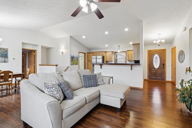 living room with vaulted ceiling, ceiling fan with notable chandelier, and dark hardwood / wood-style floors