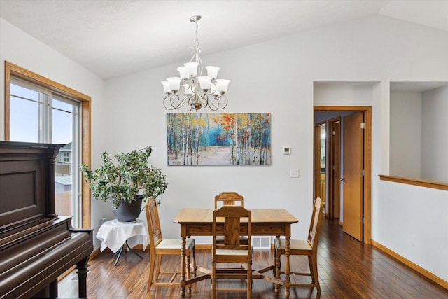 dining area featuring vaulted ceiling, dark hardwood / wood-style flooring, and a chandelier