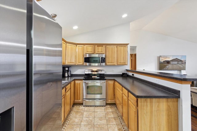 kitchen with lofted ceiling, kitchen peninsula, light tile patterned flooring, and stainless steel appliances