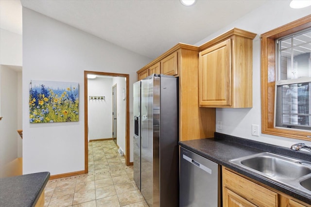 kitchen featuring light tile patterned floors, sink, appliances with stainless steel finishes, and lofted ceiling