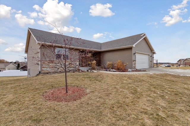 single story home with a front yard and a garage