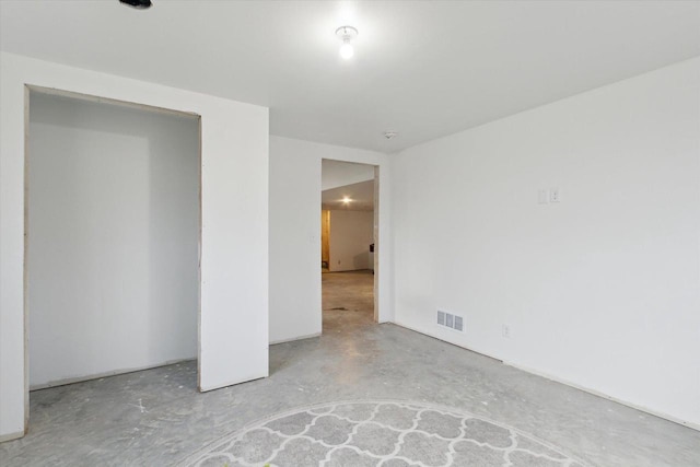 unfurnished bedroom with a closet and concrete flooring