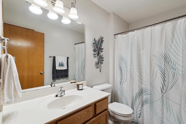 bathroom with toilet and vanity