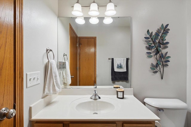 bathroom with toilet and vanity