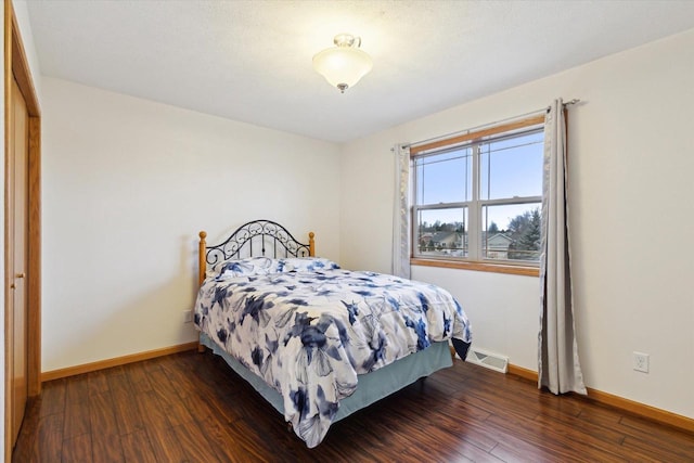 bedroom featuring a closet and dark hardwood / wood-style floors