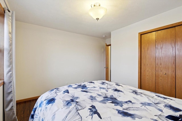 bedroom with a closet and dark hardwood / wood-style floors