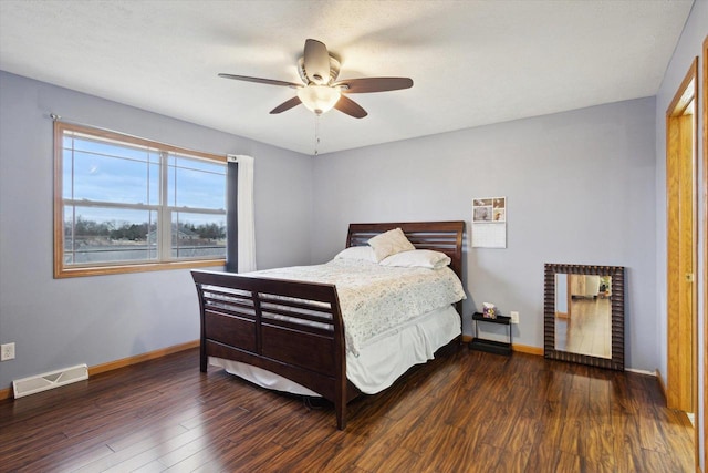 bedroom with ceiling fan and dark hardwood / wood-style flooring