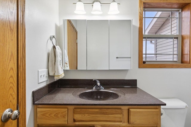 bathroom featuring toilet and vanity