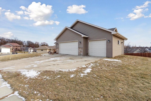 view of property exterior featuring a yard and a garage