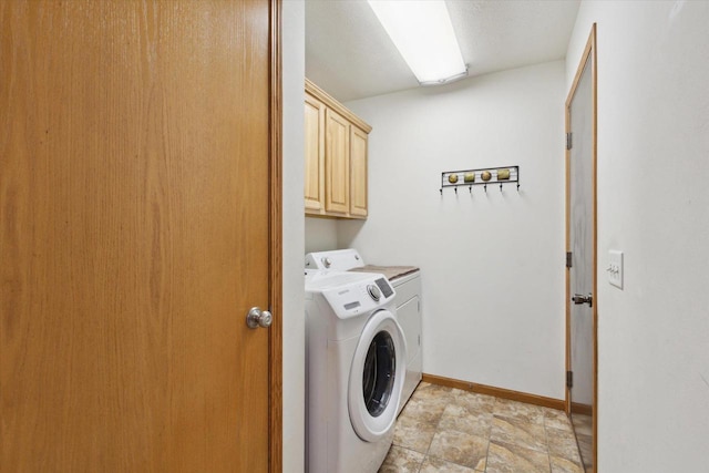 laundry area with cabinets and washer and clothes dryer