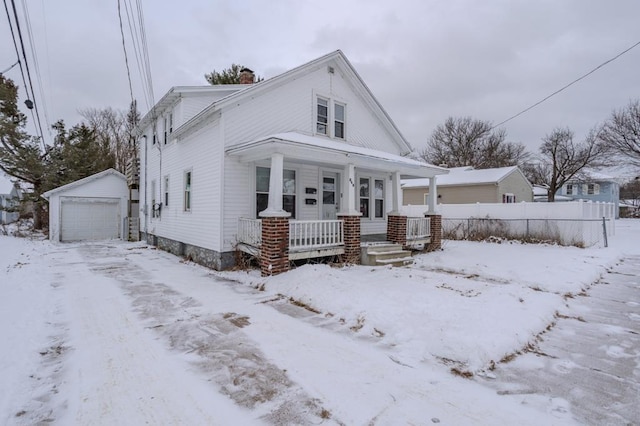 view of front of property featuring a garage, an outbuilding, and covered porch