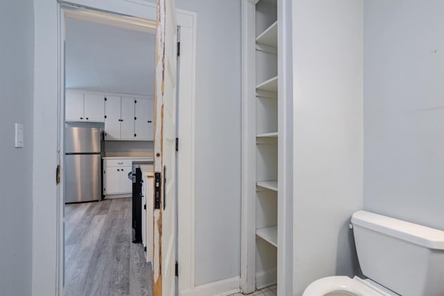 bathroom featuring hardwood / wood-style flooring and toilet