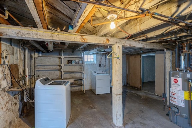 basement featuring washer and clothes dryer and gas water heater