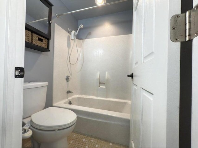 bathroom featuring toilet, shower / bathing tub combination, and tile patterned floors