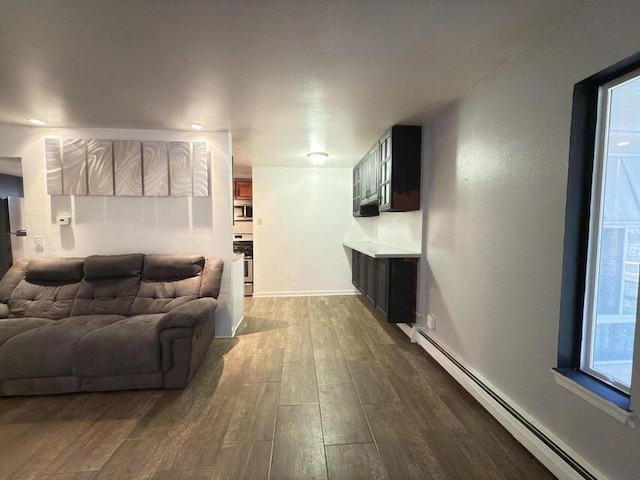 living room with wood-type flooring and a baseboard radiator