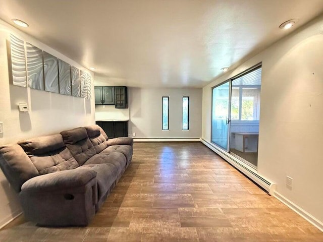 living room with hardwood / wood-style floors and a baseboard heating unit