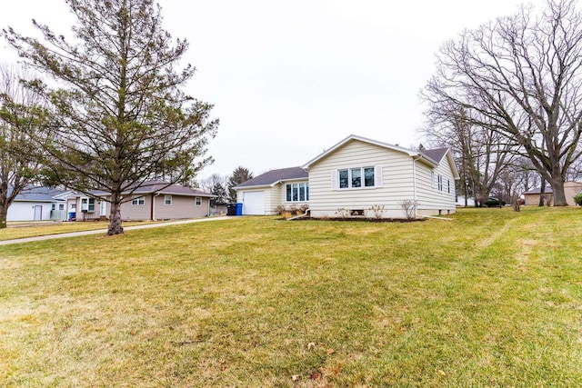 exterior space with a garage and a yard