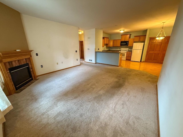 unfurnished living room featuring light carpet