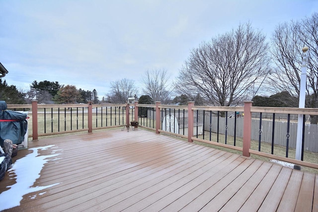 wooden deck featuring a yard