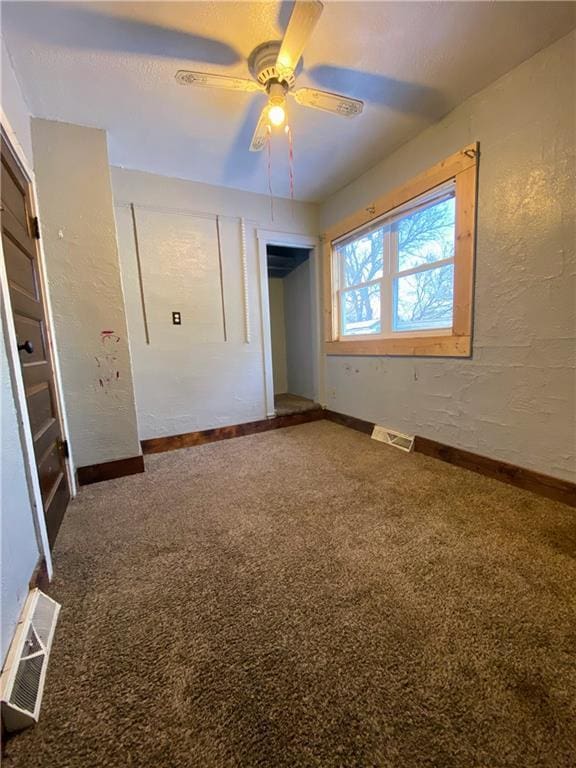 unfurnished bedroom featuring ceiling fan and carpet