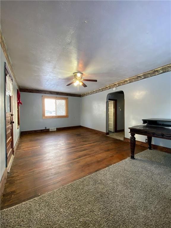 interior space featuring ceiling fan and dark hardwood / wood-style floors