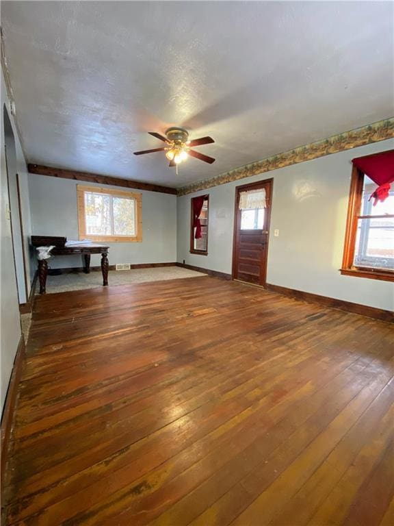 interior space with ceiling fan, plenty of natural light, and hardwood / wood-style floors