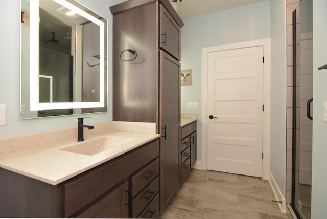 bathroom with an enclosed shower and vanity