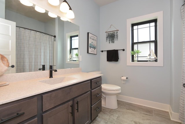 bathroom with toilet and vanity