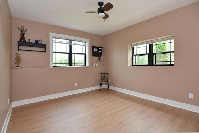 empty room featuring ceiling fan and light wood-type flooring