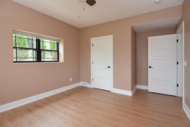 unfurnished bedroom with ceiling fan and light wood-type flooring