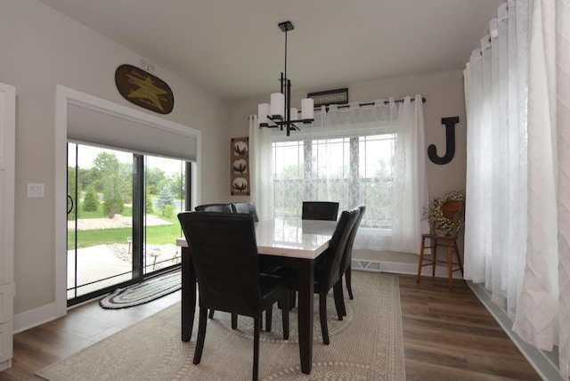 dining space featuring a chandelier and hardwood / wood-style floors