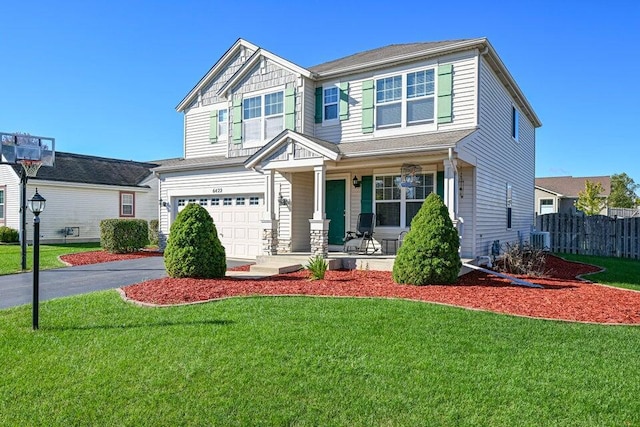 craftsman-style house featuring a front yard, central air condition unit, a porch, and a garage