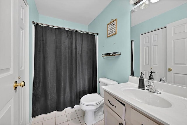 bathroom featuring toilet, vanity, and tile patterned flooring