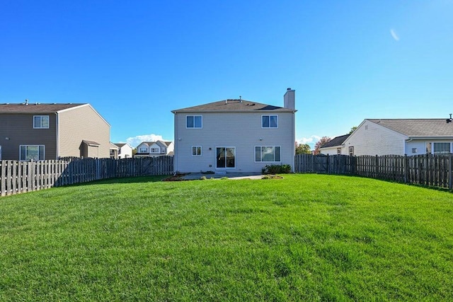 back of house featuring a patio area and a yard