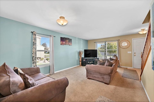 living room featuring a healthy amount of sunlight and light colored carpet