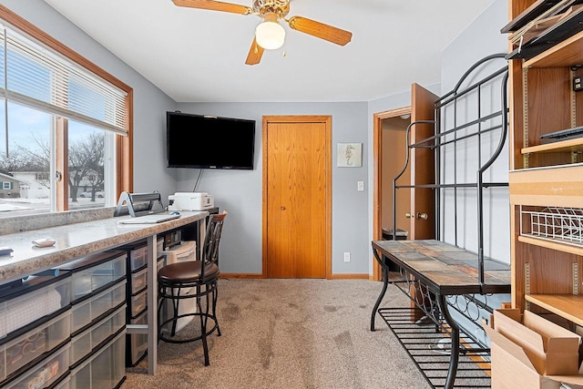 carpeted office featuring ceiling fan