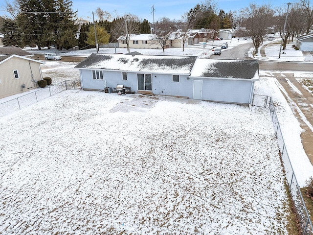 view of snow covered rear of property