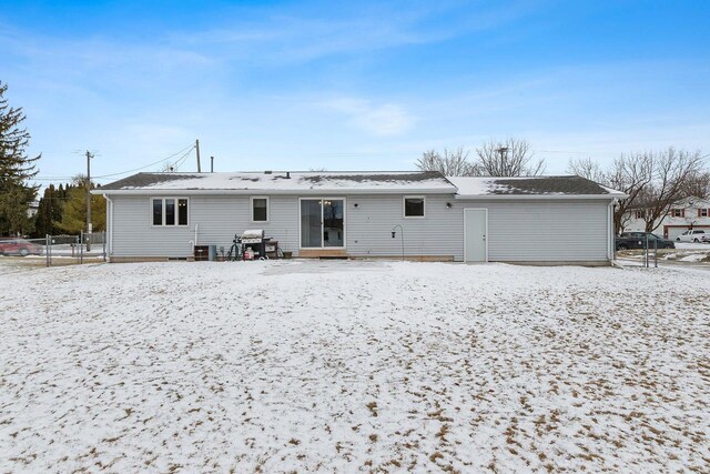 view of snow covered rear of property