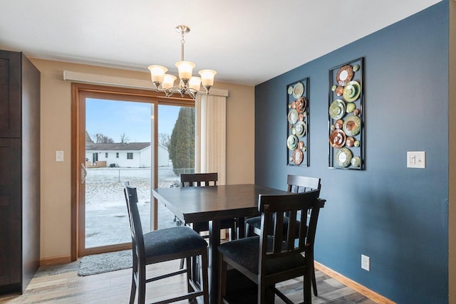 dining space featuring a chandelier and light hardwood / wood-style floors