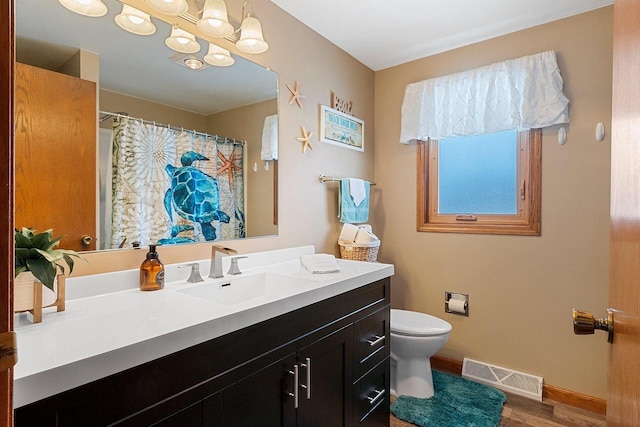 bathroom with toilet, wood-type flooring, and vanity