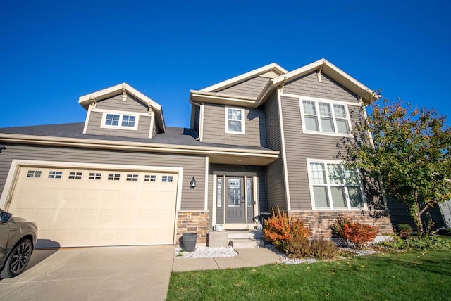 craftsman house featuring a garage, stone siding, and driveway