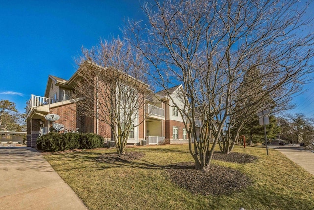 view of property exterior with a balcony, cooling unit, and a lawn