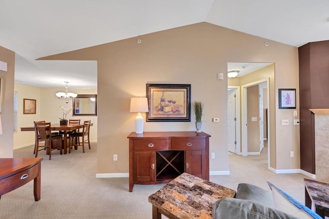 carpeted living room featuring an inviting chandelier and lofted ceiling