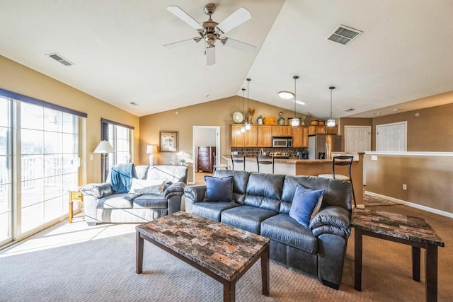 carpeted living room featuring ceiling fan and lofted ceiling