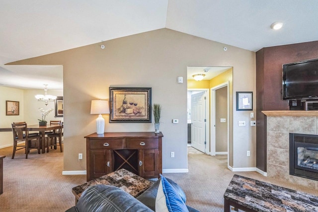 living room with light carpet, an inviting chandelier, lofted ceiling, and a fireplace