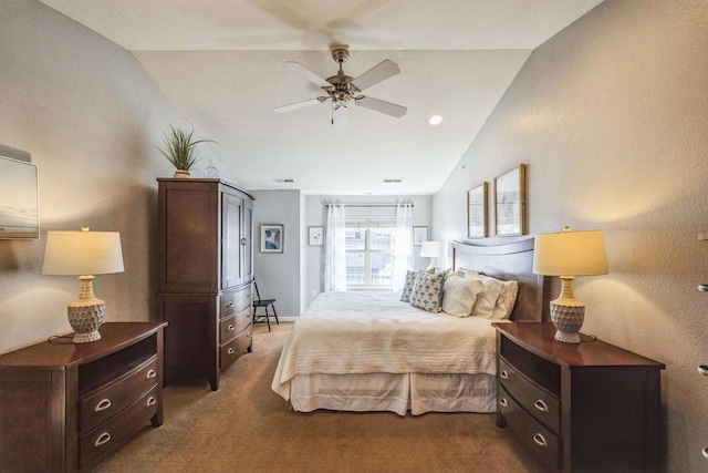 carpeted bedroom with ceiling fan and vaulted ceiling