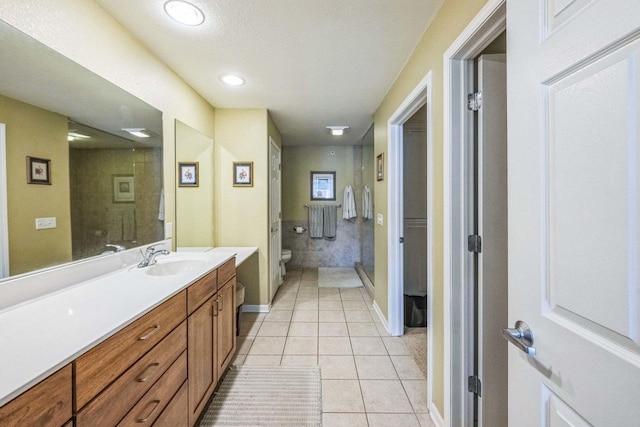 bathroom featuring toilet, vanity, and tile patterned floors