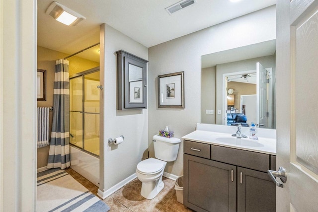 full bathroom with tile patterned flooring, vanity, bath / shower combo with glass door, toilet, and ceiling fan